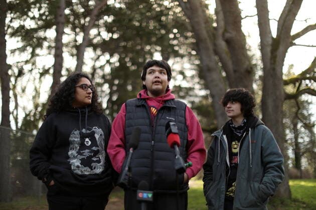 February 11, 2022, VICTORIA, BC, CANADA: Bear Henry is joined by friends Nakita Sekhon, left, and Shae Perkins during a press conference at Beacon Hill Park in Victoria, Friday, Feb. 11, 2022. Henry went missing for 74 days while participating in the old-growth logging protests in Fairy Creek in the Cowichan Valley area near Port Renfrew. Henry was found by loggers in the area before returning home safely. VICTORIA CANADA  - ZUMAc35_ 20220211_zaf_c35_191 Copyright: xChadxHipolitox