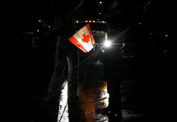 February 11, 2022, WINDSOR, ON, CANADA: A young girl dances as truckers and supporters block the access leading from the Ambassador Bridge, linking Detroit and Windsor, as truckers and their supporters continue to protest against the COVID-19 vaccine mandates and restrictions in Windsor, Ont., on Friday, February 11, 2022. WINDSOR CANADA  - ZUMAc35_ 20220211_zaf_c35_197 Copyright: xNathanxDenettex