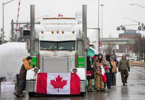 February 11, 2022, Windsor, Canada: Truckers and supporters block the access leading from the Ambassador Bridge, linking Detroit and Windsor, as truckers and their supporters continue to protest against COVID-19 vaccine mandates and restrictions, in Windsor. WINDSOR CANADA  - ZUMAc35_ 20220211_zaf_c35_114 Copyright: xNathanxDenettex