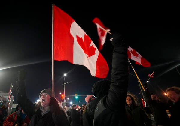 February 12, 2022, WINDSOR, ON, CANADA: A women cheers along with others as police have yet to enforce the midnight court injunction after blocking the access leading from the Ambassador Bridge, linking Detroit and Windsor, as truckers and their supporters continue to protest against the COVID-19 vaccine mandates and restrictions in Windsor, Ont., on Saturday, February 12, 2022. WINDSOR CANADA  - ZUMAc35_ 20220212_zaf_c35_044 Copyright: xNathanxDenettex