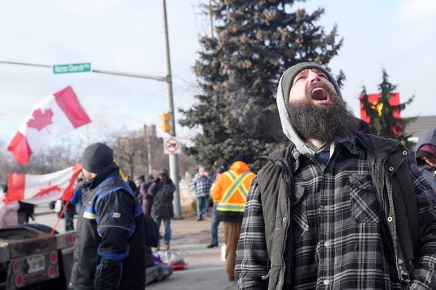 February 12, 2022, Windsor, ON, CANADA: A protester yells freedom as demonstrators prepare to leave in advance of police enforcing an injunction against their demonstration, which has blocked traffic across the Ambassador Bridge by protesters against COVID-19 restrictions, in Windsor, Ont., Saturday, Feb. 12, 2022. Windsor CANADA  - ZUMAc35_ 20220212_zaf_c35_095 Copyright: xNathanxDenettex