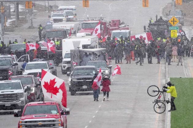 February 12, 2022, Windsor, ON, CANADA: Protesters face police officers as they enforce an injunction against their demonstration, which has blocked traffic across the Ambassador Bridge by protesters against COVID-19 restrictions, in Windsor, Ont., Saturday, Feb. 12, 2022. Windsor CANADA  - ZUMAc35_ 20220212_zaf_c35_125 Copyright: xNathanxDenettex