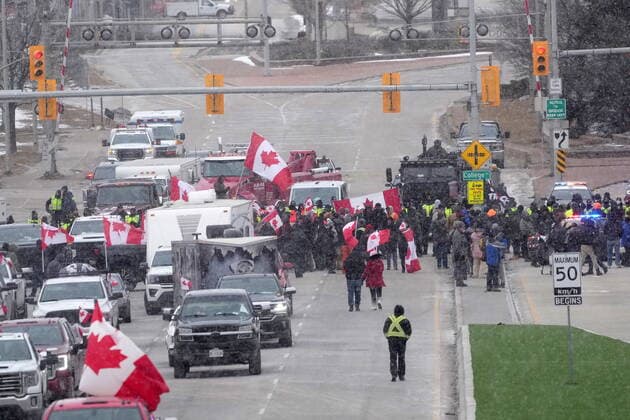 February 12, 2022, Windsor, ON, CANADA: Protesters face police officers as they enforce an injunction against their demonstration, which has blocked traffic across the Ambassador Bridge by protesters against COVID-19 restrictions, in Windsor, Ont., Saturday, Feb. 12, 2022. Windsor CANADA  - ZUMAc35_ 20220212_zaf_c35_118 Copyright: xNathanxDenettex