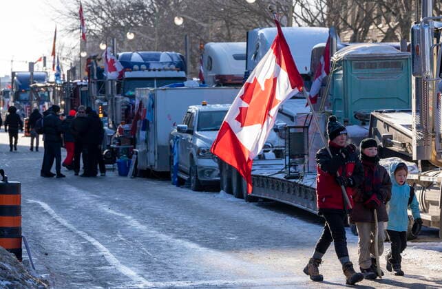February 13, 2022, Ottawa, on, Canada: Anti-mandate protesters children walk beside parked trucks near Parliament Hill in Ottawa on Sunday, February 13, 2022. Ottawa Canada  - ZUMAc35_ 20220213_zaf_c35_109 Copyright: xFrankxGunnx