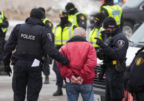 February 13, 2022, Windsor, Ontario, Canada: A protester is arrested by as police remove truckers and supporters after a court injunction gave police the power to enforce the law after blocking the access leading from the Ambassador Bridge, linking Detroit and Windsor, as truckers and their supporters continue to protest against the COVID-19 vaccine mandates and restrictions. Windsor Canada  - ZUMAc35_ 20220213_zaf_c35_060 Copyright: xNathanxDenettex