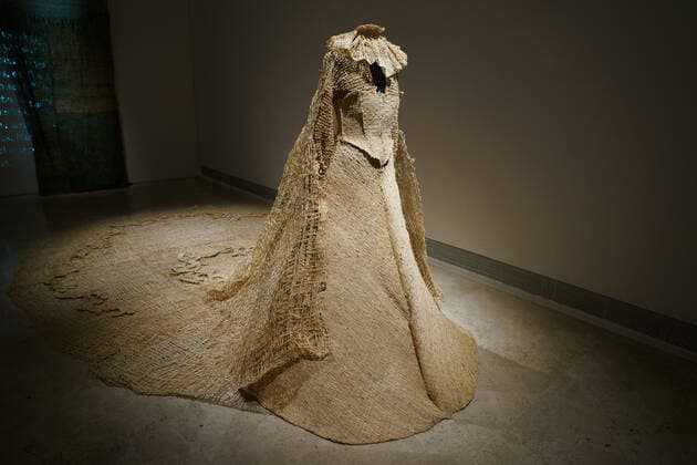 February 14, 2022, Madrid, Spain: View of a woven and embroidered raffia dress from 2019 that is part of the exhibition Memorias mestizas by the Afro-Andalusian artist Carla Hayes Mayoral (Malaga, 1997), which talks about the colonial past of Spain and Europe and which has been presented this Monday at the Thyssen museum in Madrid..The museum presents Memorias mestizas, an exhibition in which the Afro-Andalusian artist Carla Hayes Mayoral (Malaga, 1997) questions us about the colonial past of Spain and Europe, from an identity inquiry. Based on the combination of a material as characteristic of African culture as raffia and visual references from the Western collective imagination, Hayes Mayoral displays a mestizo and neo-baroque instal - ZUMAs197 20220214_zaa_s197_061 Copyright: xAtilanoxGarciax