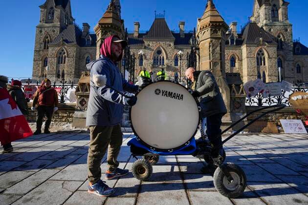 February 14, 2022, Ottawa, ON, CAN: Protesters bang on both sides of a bass drum in an effort to make a noise that will reach politicians in West Block on Parliament Hill, on the 18th day of a protest against COVID-19 measures that has grown into a broader anti-government protest, in Ottawa, on Monday, Feb. 14, 2022. Ottawa CAN  - ZUMAc35_ 20220214_zaf_c35_154 Copyright: xJustinxTangx