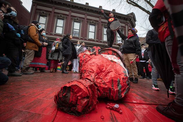 February 14, 2022, VANCOUVER, BC, CANADA: A person stands on top of the Gassy Jack statue after it was toppled and covered in red paint during the annual Women s Memorial March, in Vancouver, on Monday, February 14, 2022. The statue is a monument to Gassy Jack Deighton, a Vancouver saloon owner in the 1860s, whom Vancouver s Gastown neighbourhood is named after. The march is held to honour missing and murdered women and girls from the community with stops along the way to commemorate where women were last seen or found. VANCOUVER CANADA  - ZUMAc35_ 20220214_zaf_c35_168 Copyright: xDarrylxDyckx