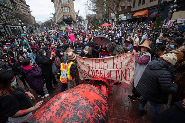 February 14, 2022, VANCOUVER, BC, CANADA: People gather around the Gassy Jack statue after it was toppled and covered in red paint during the annual Women s Memorial March, in Vancouver, on Monday, February 14, 2022. The statue is a monument to Gassy Jack Deighton, a Vancouver saloon owner in the 1860s, whom Vancouver s Gastown neighbourhood is named after. The march is held to honour missing and murdered women and girls from the community with stops along the way to commemorate where women were last seen or found. VANCOUVER CANADA  - ZUMAc35_ 20220214_zaf_c35_169 Copyright: xDarrylxDyckx