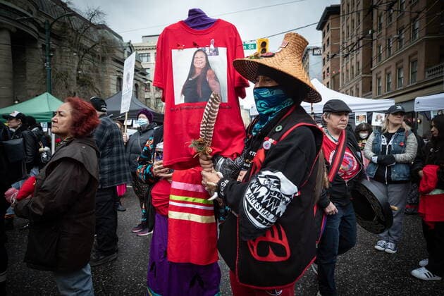 February 14, 2022, VANCOUVER, BC, CANADA: Rodney McMillan holds a t-shirt with a photo of his late sister Denise McMillan, who died of an overdose last year, as he listens to speeches before the annual Women s Memorial March, in Vancouver, on Monday, February 14, 2022. The march is held to honour missing and murdered women and girls from the community with stops along the way to commemorate where women were last seen or found. VANCOUVER CANADA  - ZUMAc35_ 20220214_zaf_c35_199 Copyright: xDarrylxDyckx