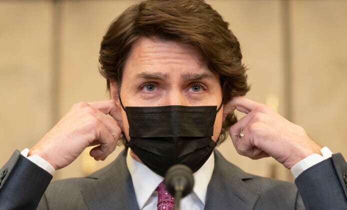 February 14, 2022, Ottawa, ON, Canada: Canadian Prime Minister Justin Trudeau removes his mask as he arrives at a news conference where he announced the Emergencies Act will be invoked to deal with protests, Monday, February 14, 2022 in Ottawa. Trudeau says he has invoked the Emergencies Act to bring to an end antigovernment blockades he describes as illegal and not about peaceful protest. Ottawa Canada  - ZUMAc35_ 20220214_zaf_c35_204 Copyright: xAdrianxWyldx
