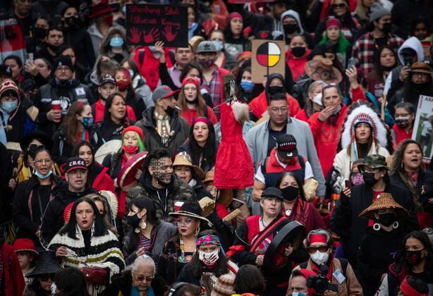 February 14, 2022, VANCOUVER, BC, CANADA: A red dress is lifted above the crowd as thousands of people participate in the annual Women s Memorial March, in Vancouver, on Monday, February 14, 2022. The march is held to honour missing and murdered women and girls from the community with stops along the way to commemorate where women were last seen or found. VANCOUVER CANADA  - ZUMAc35_ 20220214_zaf_c35_213 Copyright: xDarrylxDyckx