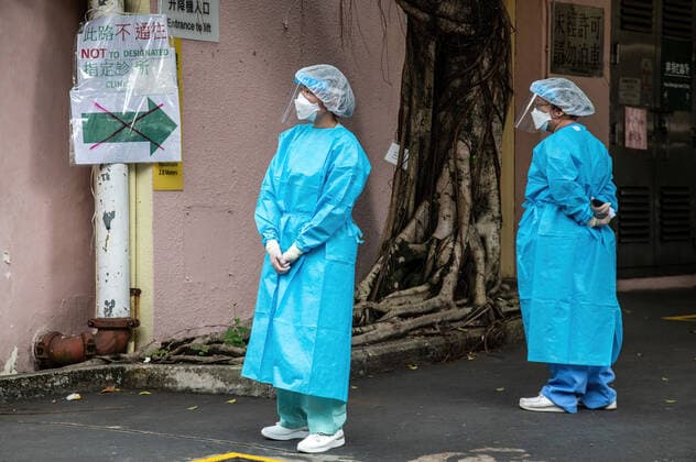February 16, 2022, Hong Kong, Hong Kong: Two health care workers await a delivery at the Shau Kei Wan Designated Clinic for COVID-19 patients..In response to the exponential rise in COVID-19 cases that are overloading Hong Kong s hospitals, the government has set up designated clinics across the city to handle those who test positive. The clinics are intended to treat those with mild symptoms, with daily quotas established and a soon-to-be launched taxi transport program. Hong Kong is currently in the fifth phase of the pandemic, recording thousands of new cases per day. Hong Kong Hong Kong - ZUMAs197 20220216_zaa_s197_025 Copyright: xBenxMaransx