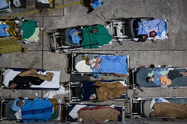 February 16, 2022, Hong Kong, China: Covid-19 patients seen lying on hospital beds at the open area outside Caritas Medical Centre..Hong Kong is struggling to contain the outbreak of Covid-19, with most of hospitals running over their capacity. Patients on hospital beds lined up outside A&E departments of the Caritas Medical Centre waiting to get into the hospital. Hong Kong China - ZUMAs197 20220216_zaa_s197_061 Copyright: xDominicxChiux