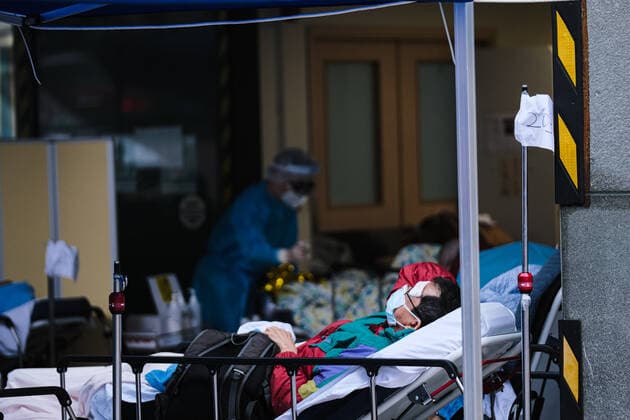 February 17, 2022, Hong Kong, China: Covid-19 patients sleep and wait at a temporary triage area outside the Caritas Medical Center hospital. As the fifth wave of Covid surges, cases worsen in Hong Kong as daily cases reaching the 5,000 mark. Hong Kong has adopted the China s Zero Covid Policy to suppress all outbreaks and by all necessary measures to get the virus under control. Hong Kong China - ZUMAt141 20220217_zap_t141_006 Copyright: xKeithxTsujix