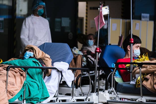 February 17, 2022, Hong Kong, China: Covid-19 patients sleep and wait at a temporary triage area outside the Caritas Medical Center hospital. As the fifth wave of Covid surges, cases worsen in Hong Kong as daily cases reaching the 5,000 mark. Hong Kong has adopted the China s Zero Covid Policy to suppress all outbreaks and by all necessary measures to get the virus under control. Hong Kong China - ZUMAt141 20220217_zap_t141_009 Copyright: xKeithxTsujix