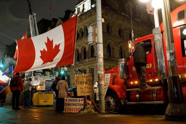 February 16, 2022, OTTAWA, ON, CANADA: A person hangs out the side of a truck, parked during a protest against COVID-19 measures that has grown into a broader anti-government protest, in Ottawa, on Wednesday, Feb. 16, 2022. OTTAWA CANADA  - ZUMAc35_ 20220216_zaf_c35_022 Copyright: xColexBurstonx