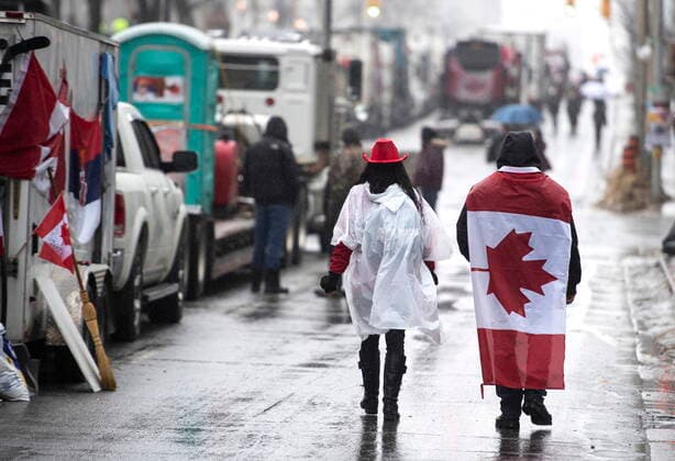 February 17, 2022, Ottawa, ON, CAN: People walk in the rain on Wellington Street on the 21st day of a protest against COVID-19 measures that has grown into a broader anti-government protest, in Ottawa, on Thursday, Feb. 17, 2022. Ottawa CAN  - ZUMAc35_ 20220217_zaf_c35_077 Copyright: xJustinxTangx