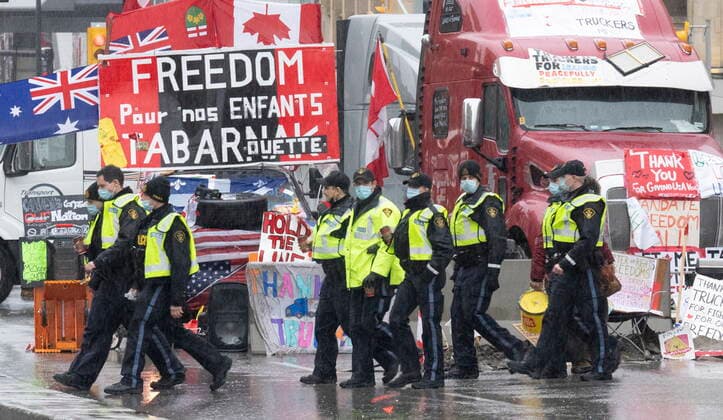 February 17, 2022, Ottawa, Canada: Police officers patrol around protest vehicles, Thursday. Police in Canada s capital are telling protesters to leave the area now as the demonstration against Covid restrictions continues. Hundreds remain in Ottawa in defiance of the newly deployed Emergencies Act. The warning came as the last remaining border blockade, at Emerson, Manitoba, came to an end yesterday. Ottawa Canada  - ZUMAc35_ 20220217_zaf_c35_004 Copyright: xAdrianxWyldx