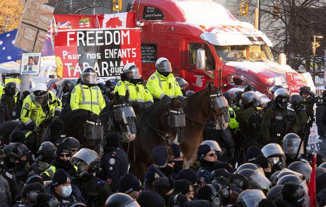 February 18, 2022, Ottawa, ON, Canada: Toronto Police mounted unit lines up behind public order units on foot as police take action to put an end to a protest, which started in opposition to mandatory COVID-19 vaccine mandates and grew into a broader anti-government demonstration and occupation, in Ottawa, Friday, Feb. 18, 2022. Ottawa Canada  - ZUMAc35_ 20220218_zaf_c35_183 Copyright: xAdrianxWyldx