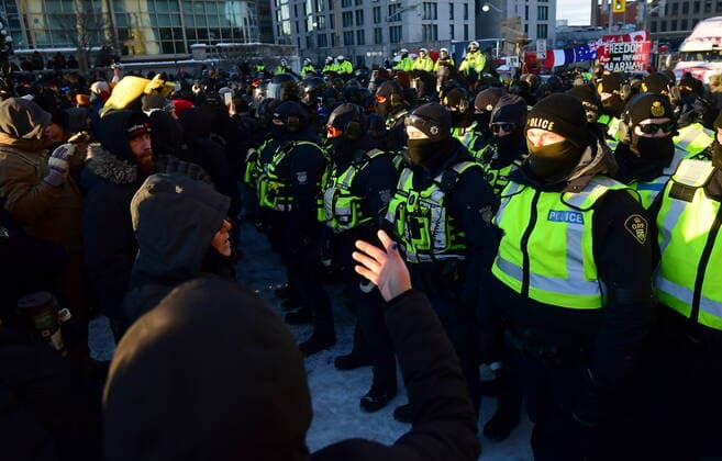 February 18, 2022, Ottawa, ON, CANADA: Protesters beg police to stand down as they take action to put an end to a protest, which started in opposition to mandatory COVID-19 vaccine mandates and grew into a broader anti-government demonstration and occupation, in Ottawa, Friday, Feb. 18, 2022. Ottawa CANADA  - ZUMAc35_ 20220218_zaf_c35_213 Copyright: xJustinxTangx