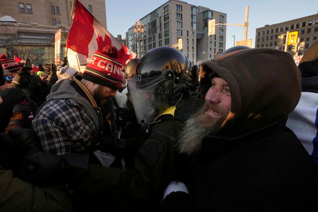 February 18, 2022, Ottawa, CANADA: Protesters meet police in close quarters as authorities take action to put an end to a protest, which started in opposition to mandatory COVID-19 vaccine mandates and grew into a broader anti-government demonstration and occupation, in Ottawa, Friday. Ottawa CANADA  - ZUMAc35_ 20220218_zaf_c35_182 Copyright: xAdrianxWyldx