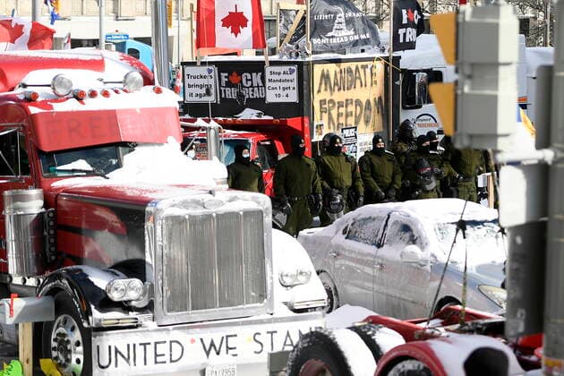 February 18, 2022, Ottawa, Ontario, Canada: Police hold a line as they work to bring a protest, which started in opposition to mandatory COVID-19 vaccine mandates and grew into a broader anti-government demonstration and occupation, to an end, in Ottawa. Ottawa CANADA  - ZUMAc35_ 20220218_zaf_c35_122 Copyright: xJustinxTangx