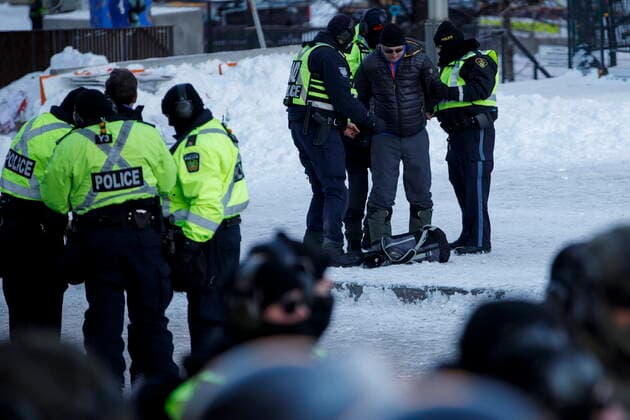 February 18, 2022, OTTAWA, ON, CANADA: Police officers detain a protestor during a protest against COVID-19 measures that has grown into a broader anti-government protest continues to occupy downtown Ottawa on Friday, Feb. 18, 2022. OTTAWA CANADA  - ZUMAc35_ 20220218_zaf_c35_237 Copyright: xColexBurstonx