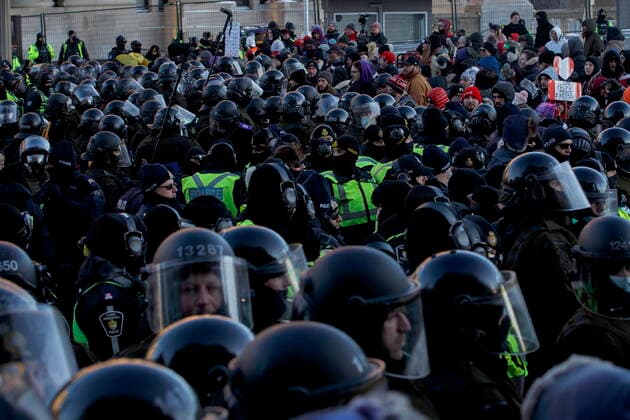 February 18, 2022, OTTAWA, ON, CANADA: Police officers push back protestors during a protest against COVID-19 measures that has grown into a broader anti-government protest continues to occupy downtown Ottawa on Friday, Feb. 18, 2022. OTTAWA CANADA  - ZUMAc35_ 20220218_zaf_c35_241 Copyright: xColexBurstonx
