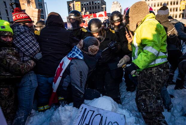 February 18, 2022, Ottawa, ON, CAN: Police push forward as protesters attempt to maintain their position at a blockade of vehicles at Rideau Street as police work to end an ongoing protest against COVID-19 measures that has grown into a broader anti-government protest, on its 22nd day, in Ottawa, on Friday, Feb. 18, 2022. Ottawa CAN  - ZUMAc35_ 20220218_zaf_c35_246 Copyright: xJustinxTangx