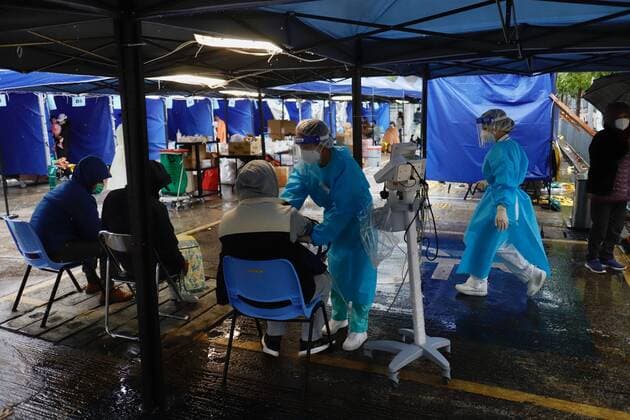 February 19, 2022, HONG KONG, CHINA: A nurse taking blood pressure of an awaiting patient under a makeshift tent outside Caritas Medical Centre.Hospitals in Hong Kong are forced to set up makeshift area outside of hospital buildings for patients as medical system buckle under enormous pressure of overload.Feb-19,2022Hong Kong.ZUMA HONG KONG CHINA - ZUMAl137 20220219_zap_l137_007 Copyright: xLiauxChung-renx