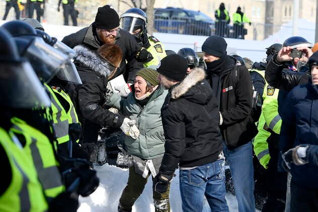 February 19, 2022, Ottawa, ON, CANADA: A protester cries as police take action to put an end to a protest, which started in opposition to mandatory COVID-19 vaccine mandates and grew into a broader anti-government demonstration and occupation, in Ottawa, Saturday, Feb. 19, 2022. Ottawa CANADA  - ZUMAc35_ 20220219_zaf_c35_077 Copyright: xJustinxTangx