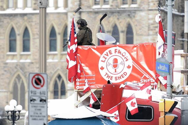February 19, 2022, Ottawa, ON, CANADA: An RCMP tactical officer surveys the scene from the top of a shed built by protesters on a flatbed truck as police take action to put an end to a protest, which started in opposition to mandatory COVID-19 vaccine mandates and grew into a broader anti-government demonstration and occupation, in Ottawa, Saturday, Feb. 19, 2022. Ottawa CANADA  - ZUMAc35_ 20220219_zaf_c35_082 Copyright: xJustinxTangx