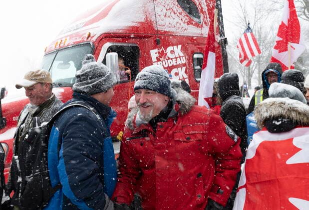 February 19, 2022, QUEBEC, PQ, Canada: Bernard Rambo Gauthier, centre, shakes hand with supporters as hundreds of people demonstrate against COVID-19 measures in front of the legislature in Quebec City, Saturday, Feb. 19, 2022. QUEBEC Canada  - ZUMAc35_ 20220219_zaf_c35_089 Copyright: xJacquesxBoissinotx