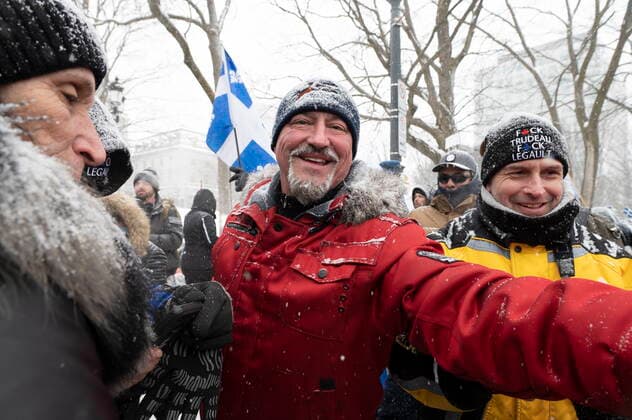 February 19, 2022, QUEBEC, PQ, Canada: Bernard Rambo Gauthier, centre, shakes hand with supporters as hundreds of people demonstrate against COVID-19 measures in front of the legislature in Quebec City, Saturday, Feb. 19, 2022. QUEBEC Canada  - ZUMAc35_ 20220219_zaf_c35_092 Copyright: xJacquesxBoissinotx