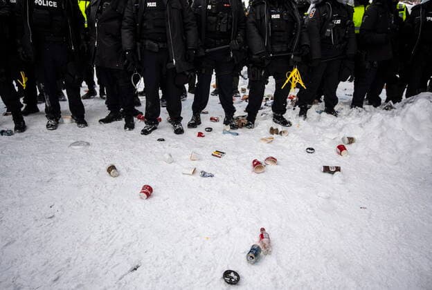 February 19, 2022, Ottawa, ON, Canada: Garbage is spilled on the ground as poolice move in to clear downtown Ottawa near Parliament Hill of protesters after weeks of demonstrations on Saturday, Feb. 19, 2022. Police arrested scores of demonstrators and towed away vehicles Friday in Canada s besieged capital, and a stream of trucks started leaving under the pressure, raising authorities hopes for an end to the three-week protest against the country s COVID-19 restrictions. Ottawa Canada  - ZUMAc35_ 20220219_zaf_c35_144 Copyright: xJustinxTangx