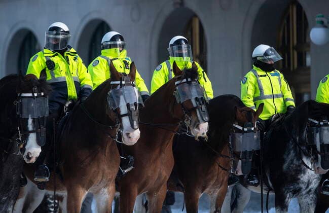 February 19, 2022, Ottawa, ON, Canada: Toronto Police mounted unit stand on Wellington Street as police work to clear the streets in front of Parliament Hill to end to a protest, which started in opposition to mandatory COVID-19 vaccine mandates and grew into a broader anti-government demonstration and occupation, on its 23rd day, in Ottawa, Saturday, Feb. 19, 2022. Ottawa Canada  - ZUMAc35_ 20220219_zaf_c35_176 Copyright: xJustinxTangx