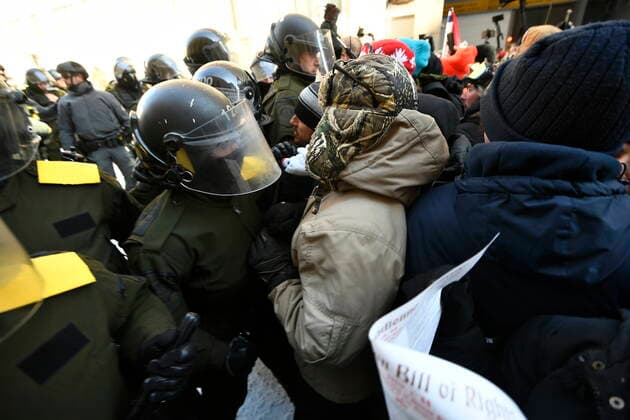February 19, 2022, Ottawa, ON, CANADA: Police push back protesters as they take action to put an end to a protest, which started in opposition to mandatory COVID-19 vaccine mandates and grew into a broader anti-government demonstration and occupation, in Ottawa, Saturday, Feb. 19, 2022. Ottawa CANADA  - ZUMAc35_ 20220219_zaf_c35_211 Copyright: xJustinxTangx