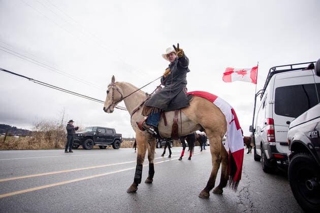 February 19, 2027, Surrey, British Columbia, Canada: A person on a horse flashes a peace sign at the freedom convoy in Surrey, BC. Surrey Canada - ZUMA Pho 20270219_mda_w171_708 Copyright: xRyanxWalterxWagnerx