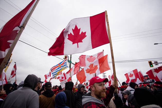February 19, 2027, Surrey, British Columbia, Canada: A crowd of people waving mainly Canadian flags gathers at the intersection of 8th ave and 172 St to protest vaccine mandates. Surrey Canada - ZUMA Pho 20270219_mda_w171_711 Copyright: xRyanxWalterxWagnerx