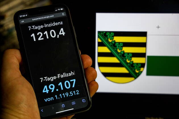 Coronavirus in Germany Covid 19 Robert Koch Institute DEU dashboard, Germany, Saxony 20 02 2022 The 7-day incidence for the state Cases last 7 days 100 000 p.e. is displayed on an iPhone, with the state coat of arms in the background.