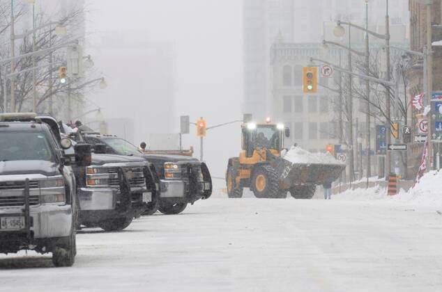 February 20, 2022, Ottawa, ON, Canada: Heavy equipment is used to remove show from Wellington Street in downtown Ottawa on Sunday, Feb. 20, 2022. A protest, which was first aimed at a COVID-19 vaccine mandate for cross-border truckers but also encompassed fury over the range of COVID-19 restrictions. Ottawa Canada  - ZUMAc35_ 20220220_zaf_c35_049 Copyright: xAdrianxWyldx