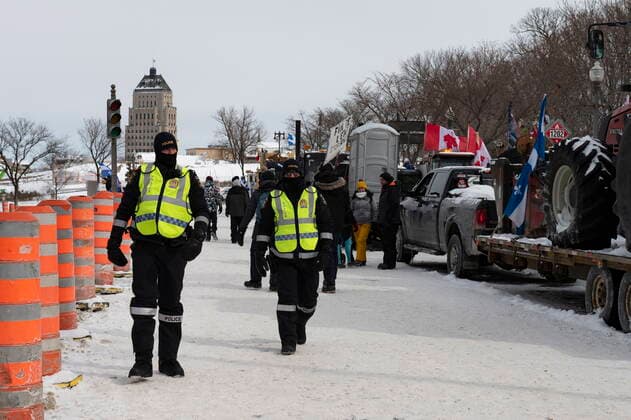 February 20, 2022, QUEBEC, PQ, Canada: Police officers patrol the street as hundreds of people demonstrate against COVID-19 measures Sunday, February 20, 2022 in front of the legislature in Quebec City. QUEBEC Canada  - ZUMAc35_ 20220220_zaf_c35_071 Copyright: xJacquesxBoissinotx