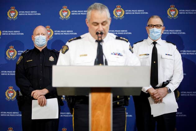 February 20, 2022, OTTAWA, ON, CANADA: Ottawa interim police chief Steve Bell, left, and Ontario Provincial Police deputy commissioner Chris Harkins listen as RCMP deputy commissioner Mike Duheme speaks to reporters during a press conference in Ottawa, Sunday, Feb. 20, 2022. OTTAWA CANADA  - ZUMAc35_ 20220220_zaf_c35_085 Copyright: xColexBurstonx