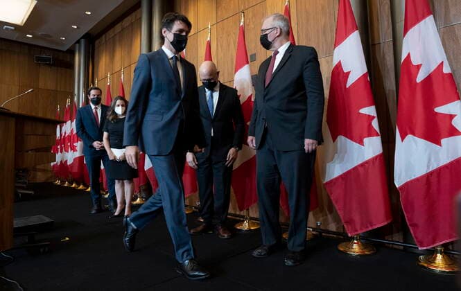 February 21, 2022, Ottawa, ON, Canada: Prime Minister Justin Trudeau leaves a news conference with Public Safety Minister Marco Mendicino, Deputy Prime Minister and Finance Minister Chrystia Freeland, Justice Minister and Attorney General of Canada David Lametti and President of the QueenöÄÃ s Privy Council for Canada and Emergency Preparedness Minister Bill Blair, Monday, Feb. 21, 2022 in Ottawa. Ottawa Canada  - ZUMAc35_ 20220221_zaf_c35_022 Copyright: xAdrianxWyldx