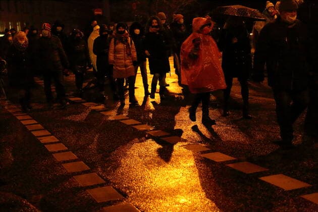 Demonstrators walk across Friedrich Ebert Straße during a demonstration against compulsory vaccination in the coronavirus pandemic, Potsdam, Germany, Feb. 21, 2022 Demo against compulsory vaccination