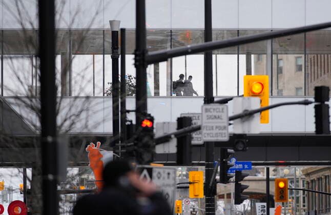 February 22, 2022, Ottawa, ON, Canada: CORRECTS S NAME TO Police officers walk across a skybridge connected to the Rideau Centre in Ottawa on Tuesday, Feb. 22, 2022. Ottawa s largest mall has been evacuated and a suspect has been arrested with a possible weapon, on the first day the mall has been open since protests forced stores to shut down late last month. Ottawa Canada  - ZUMAc35_ 20220222_zaf_c35_028 Copyright: xJustinxTangx