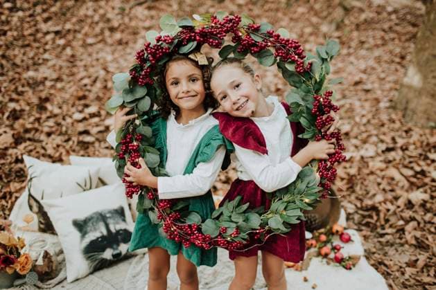 Smiling girls holding Christmas wreath in autumn forest model released, GMLF01249
