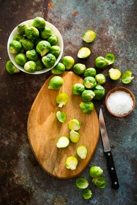 Halved Brussels sprouts on cutting board, GIOF14809