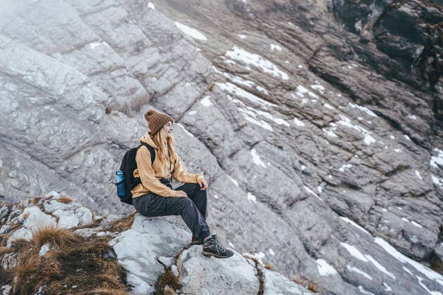 Woman sitting on mountain at Caucasus Nature Reserve in Sochi, Russia model released, OMIF00597